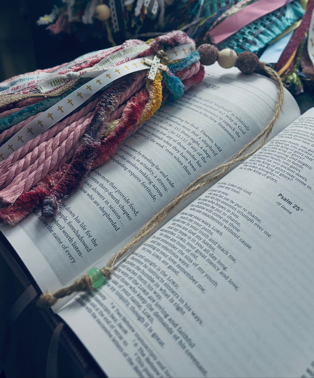 Colorful fabric bookmark with tassels on an open book