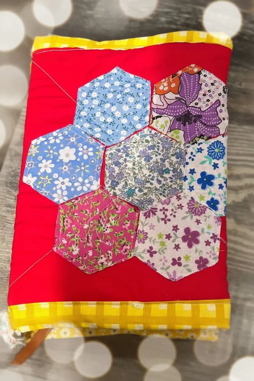 Hexagonal patchwork fabric on a red background with yellow border