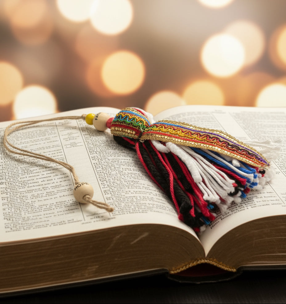 Colorful tassel with beads on open Bible