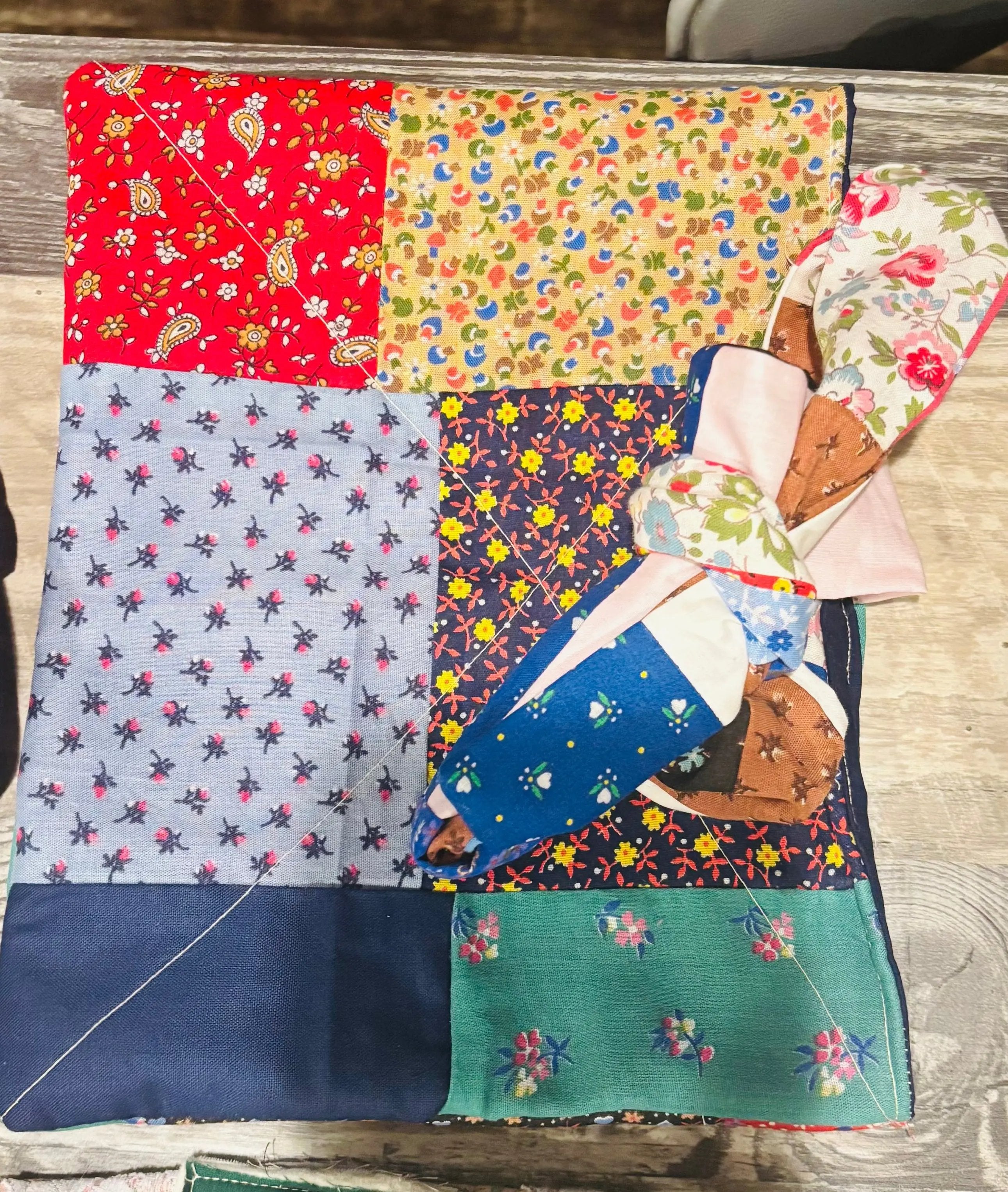Collection of colorful fabric patches on a handmade bible book sleeve