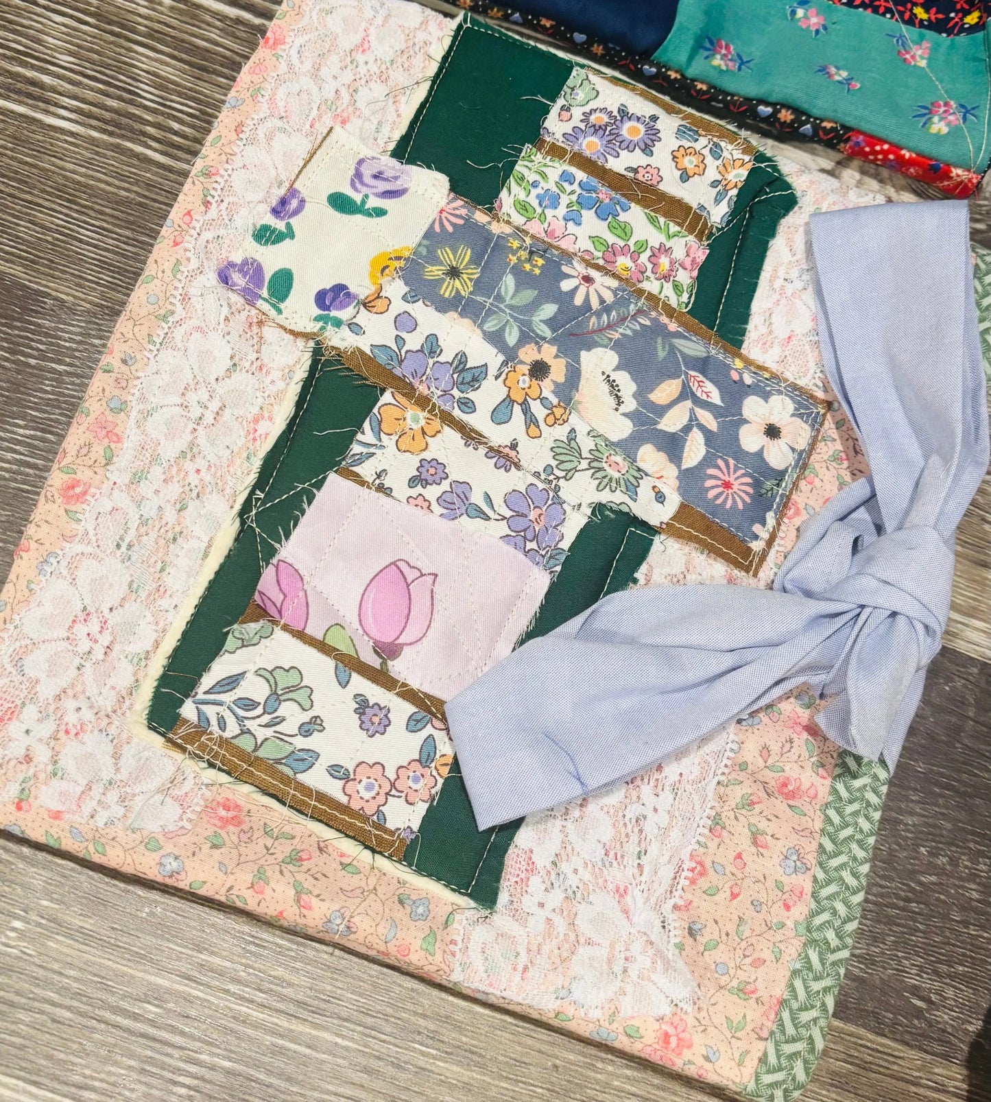 Patchwork cross design book sleeve/ bible sleeve with straps tied in a bow.