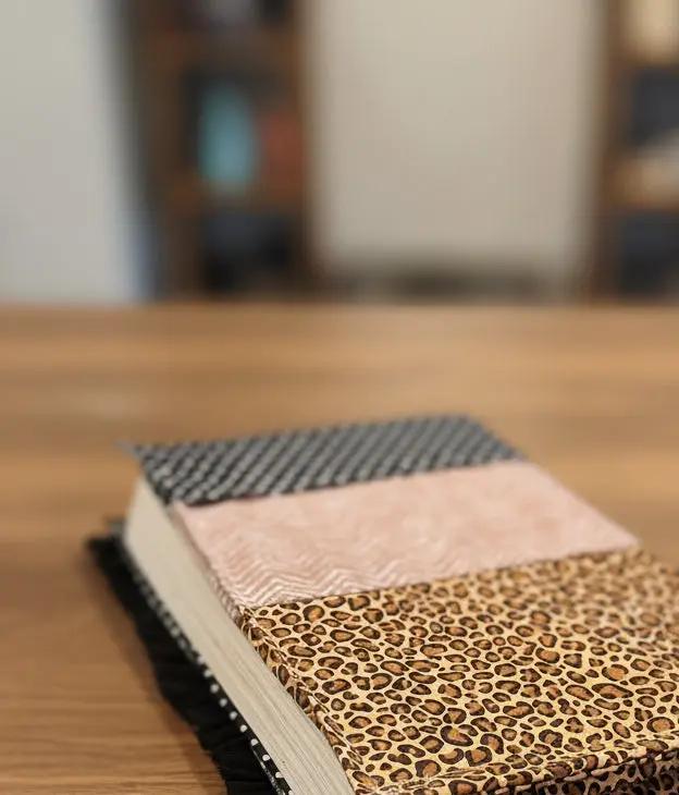 Three fabric choices with different patterns on a quilted bible cover 