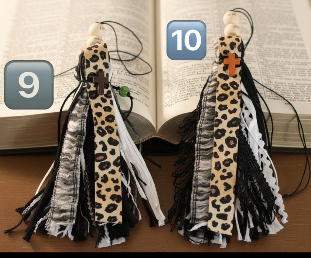Two decorative items with leopard print and tassels on a wooden surface.