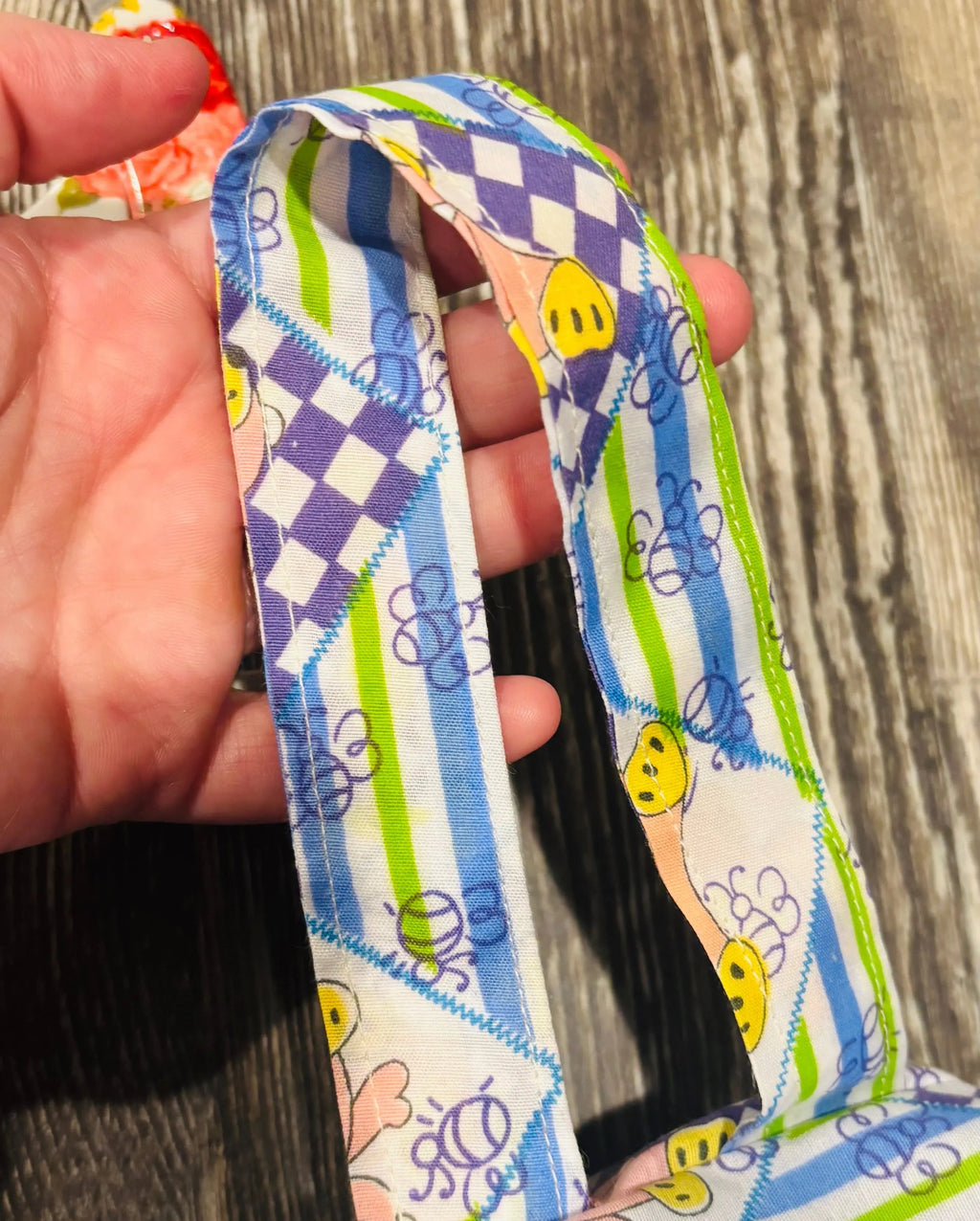 durable strap featured on diaper and wipe clutch for mom of young children or babies