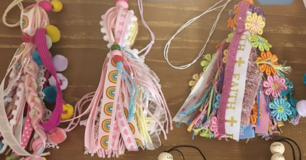 Decorative ribbons with colorful embellishments on a wooden surface