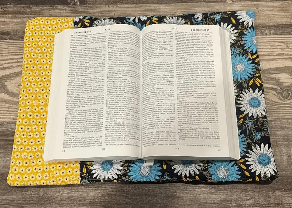 Open book on a floral fabric with a ruler and cutting mat in the background