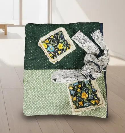 Patchwork quilted bible or book sleeve with floral and geometric patterns on a wooden surface